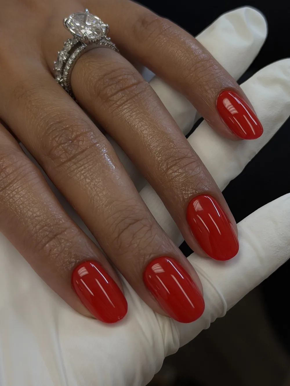 Bright red oval gel manicure on natural-length nails
