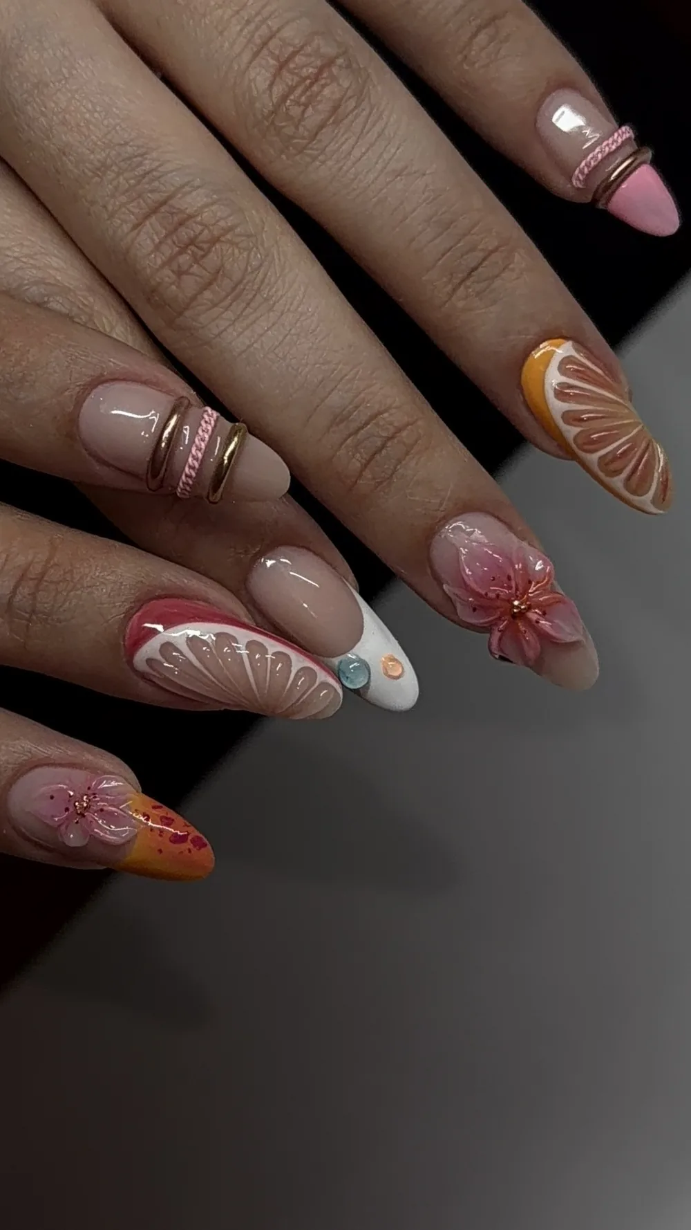 Citrus slice and 3D floral nail art on almond extensions