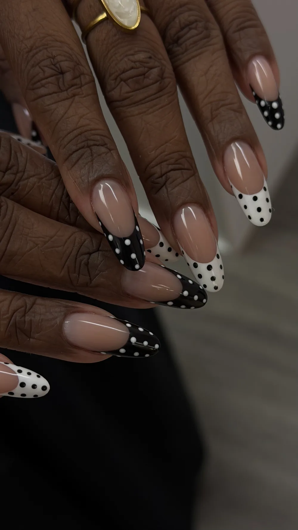 Monochrome polka dot French tips on long almond nails